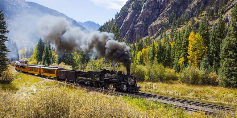 Durango and Silverton Railroad steaming through valley.