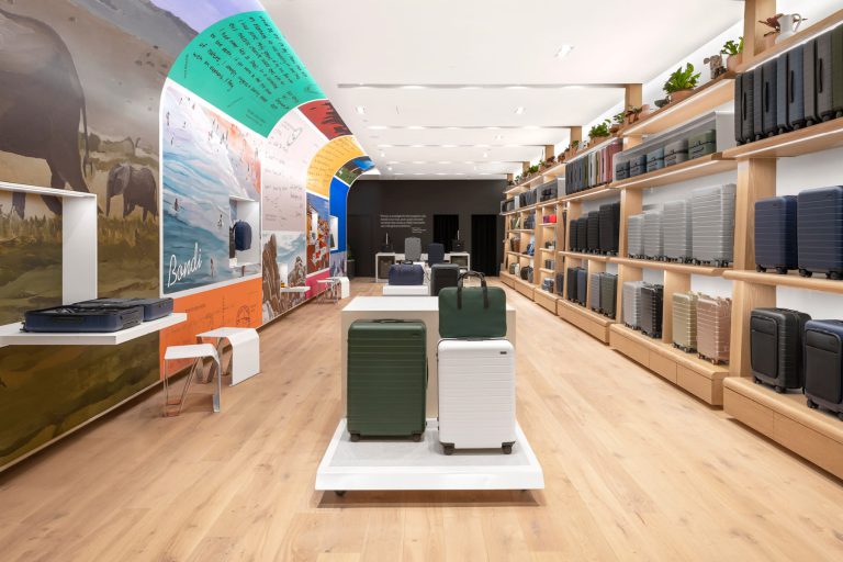 Travel focused retail shop with suitcases and colorful walls.