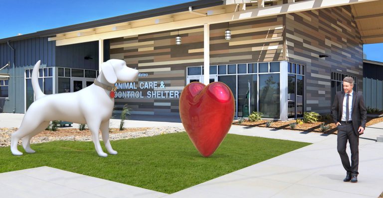 Oversided sculpture of a big white dog and large red heart.