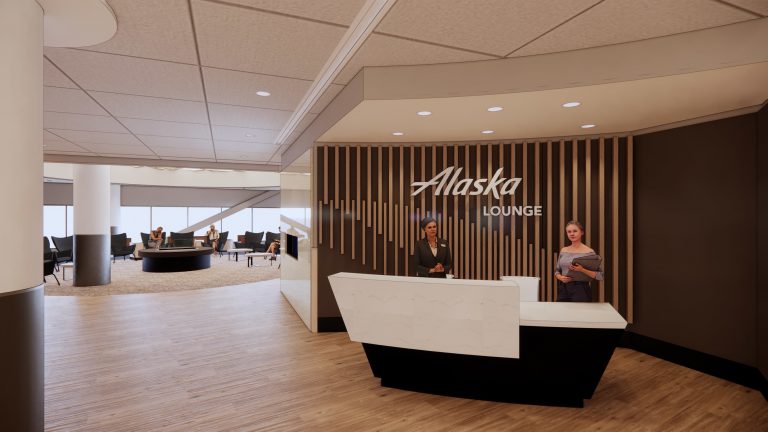 Marble welcome desk against wooden slat wall of Alaska Lounge in SFO.