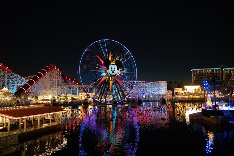 Colorfil ferris wheel reflecting on a lake at Disney California Adventure.