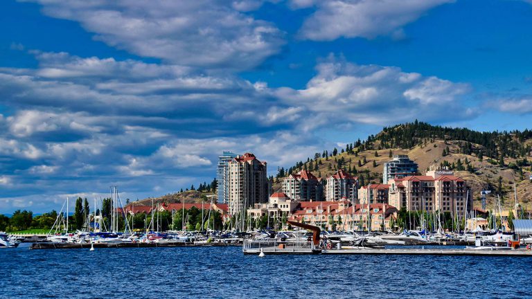 Blue waters and sky with tall hotels in background.