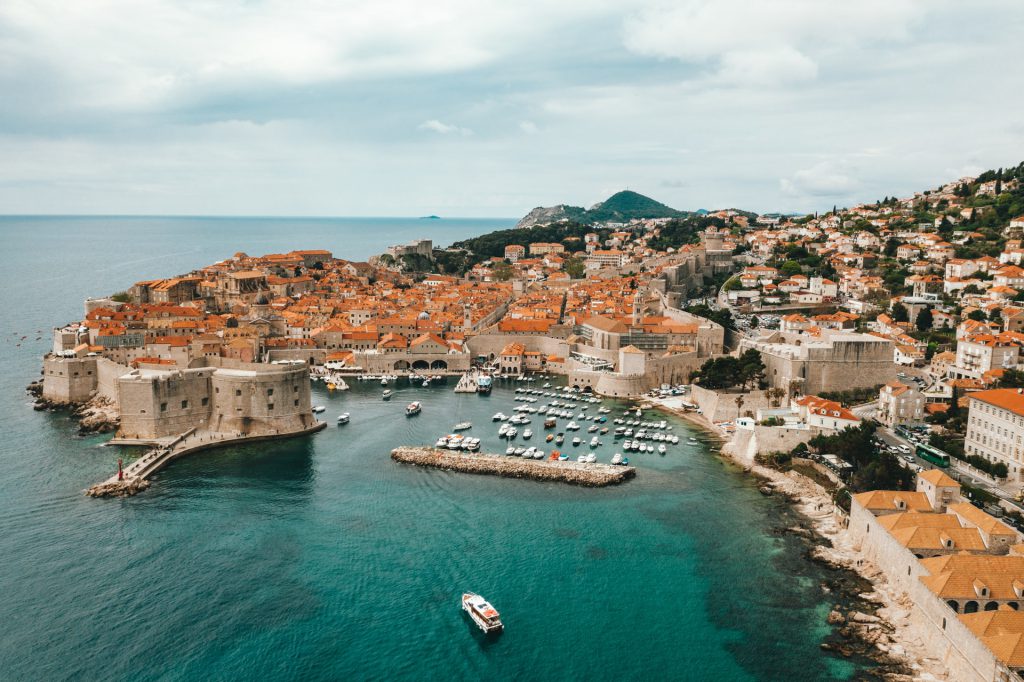 Red roof buildings along a blue sea in Croatia.