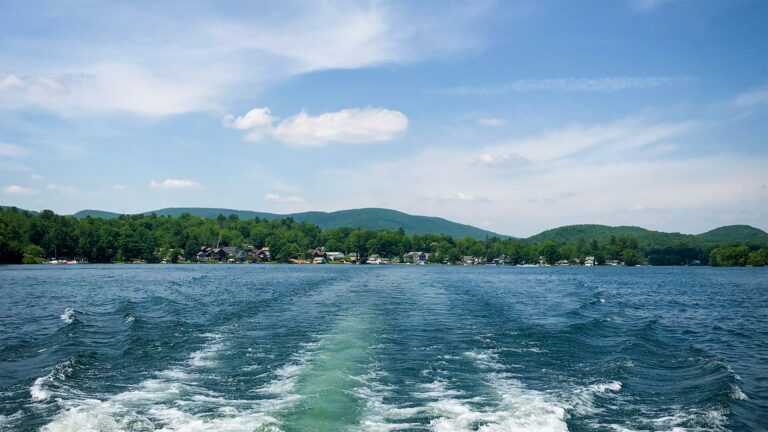 Green hills against the blue waters of a lake and sky.