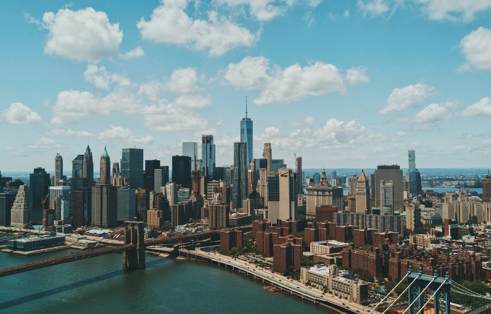 wide angle photo of Brooklyn Bridge under cloudy sky