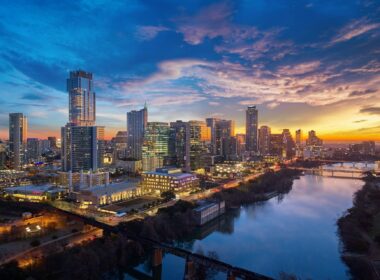 Austin skyline along the Colorado River during a colorful sunrise.