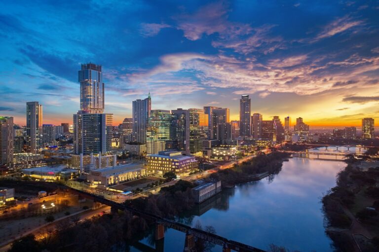 Austin skyline along the Colorado River during a colorful sunrise.